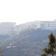 The Getty Center lies shrouded in smoke as seen from the Bel Air district of Los Angeles after the Skirball wildfire swept through Wednesday, Dec. 6, 2017. Image: AP Photo/Reed Saxon